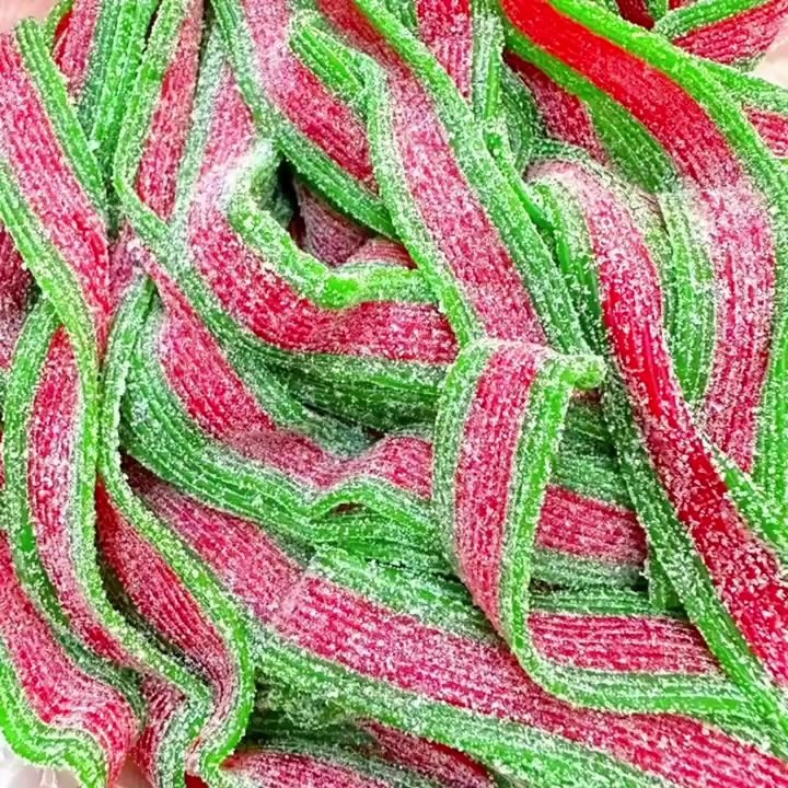 Rainbow sour sanded gummy strips in red and green, produced by a double-colour gummy extruder line